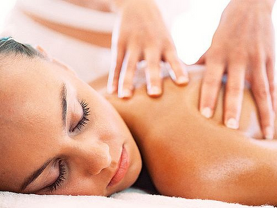 Closeup of a woman's face with her eyes closed as she gets KB Fitness Mobile Swedish Massage