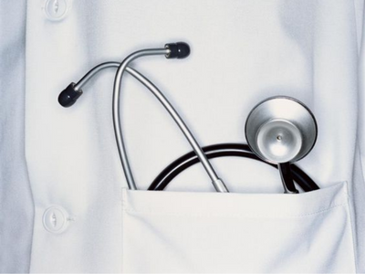 Closeup of a stethoscope in the pocket of a white medical coat