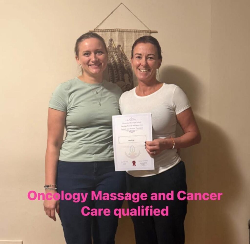 Kelly Briggs proudly holding her diploma in Oncology Massage and Cancer Care.